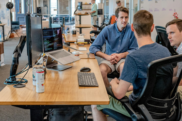 Three Men Sitting On Chair Beside Tables B1e9e0e411558a7d0a14981dcbaabeb3